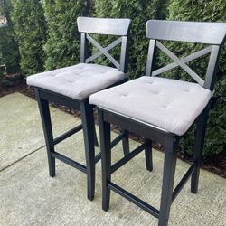 two solid wood counter top chairs with cushions removable in great condition 25 in H