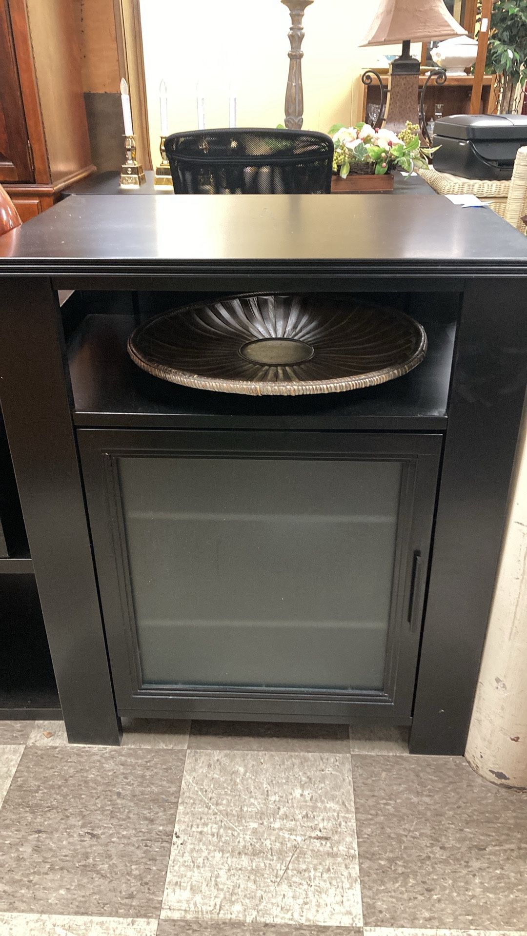 Black cabinet with glass door and three shelves