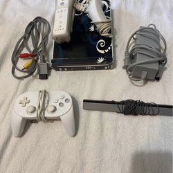 Wii console with cords, controllers, and games built in.