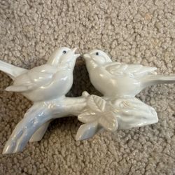 Vintage porcelain figurine featuring two birds perched on a branch
