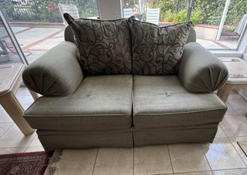 Green Loveseat Sofa with Patterned Cushins