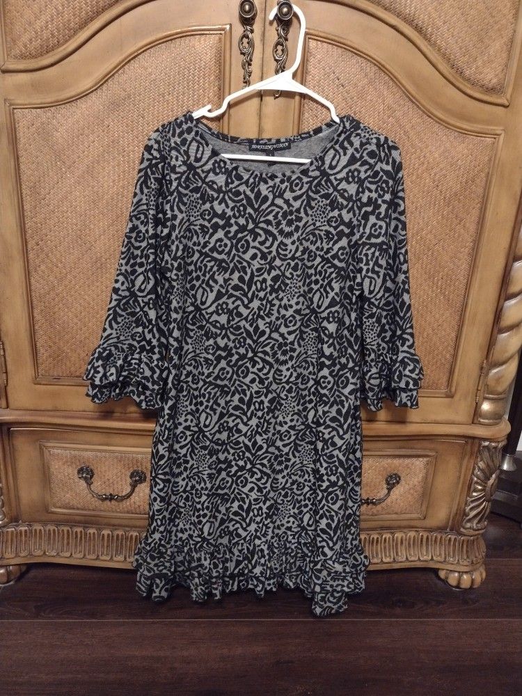 Black and grey dress with ruffle details on sleeve and hemline. By Addressing Women, size large. 