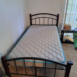 Solid Wood and Metal Twin bed in great condition with Matress sheets and foam pads.