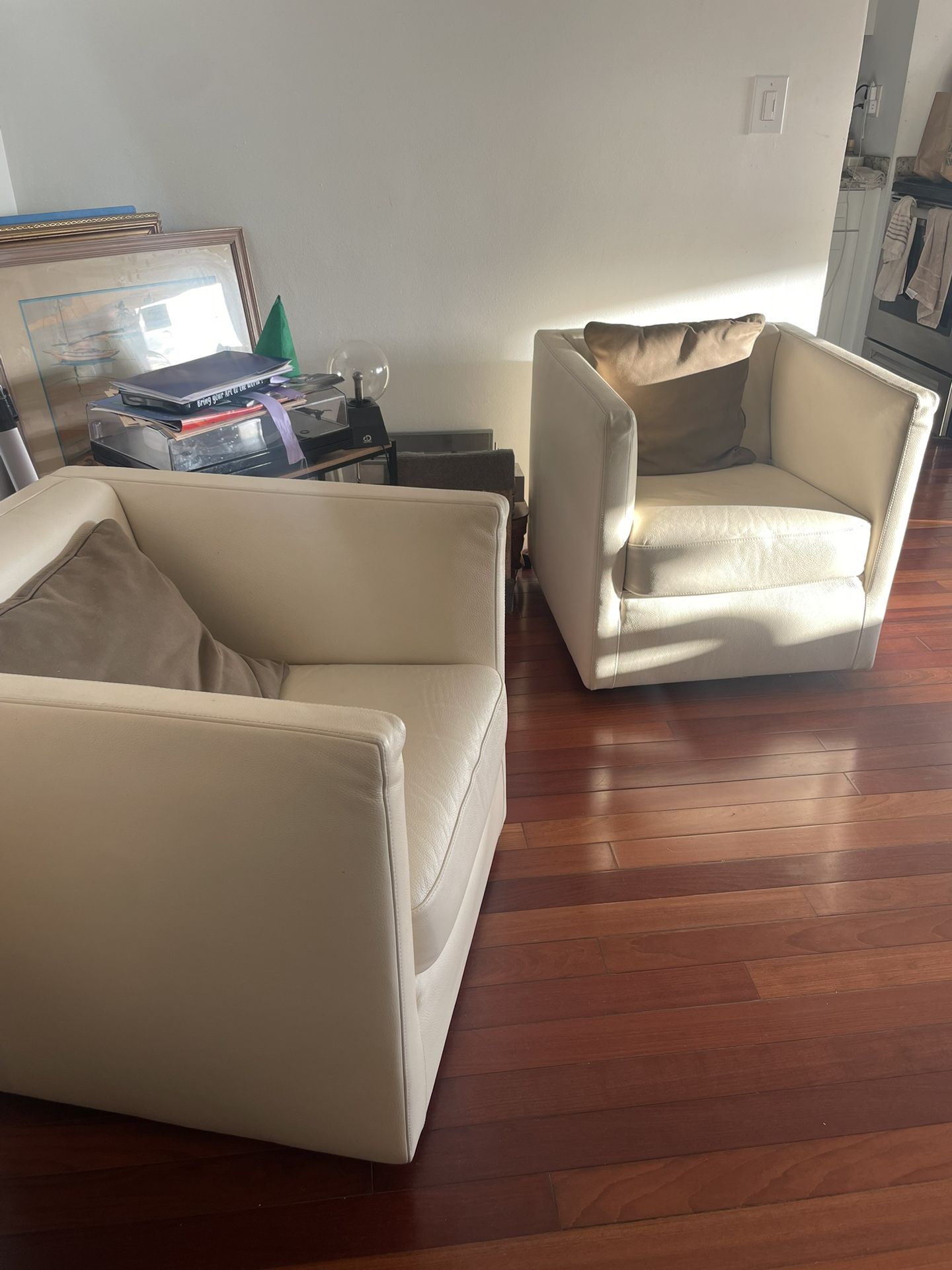 Off White Leather Swivel Armchairs