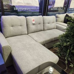 Reversible fabric sectional with sleeper and storage