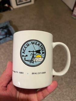 vintage AccuWeather ceramic coffee mug featuring an early company logo with a weather station graphic and the address "619 West College" in State Coll