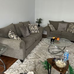 2 Two Piece, Gray Couch, And 3 peace Coffee Table. The Condition Is Good.