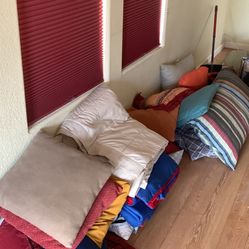 Assortment of throw pillows and blankets
