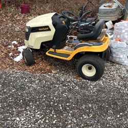 A cub cadet, yellow and black twin cam and has a mower with it