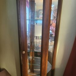 Cute Dark Wood mirrored curio with light and glass shelves. Lower cabinet
24"w x 10.5"d x 70.75"h