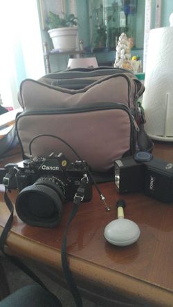 55 mm Old Canon camera with flash and bag