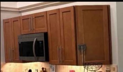 A Set of 12 pre-owned Oak Panal kitchen Cabinets w/Brushed Nickel Hardware