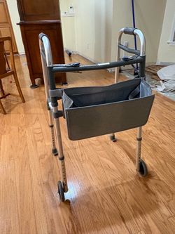 Folding walker with storage bag
