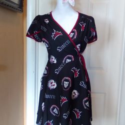Stylish dress featuring a bold black and red design with 'Queen' print. Perfect for making a statement.