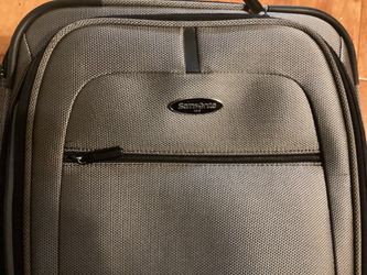 Samsonite Carry On Luggage.( Grey) Dimensions are: 14”W —9”D — 22”H.