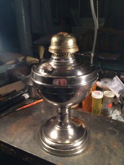 Early Turn-of-the-Century polished nickel and brass Oil Lamp. In working condition. One tiny, tiny dimple you have to look really hard to see.