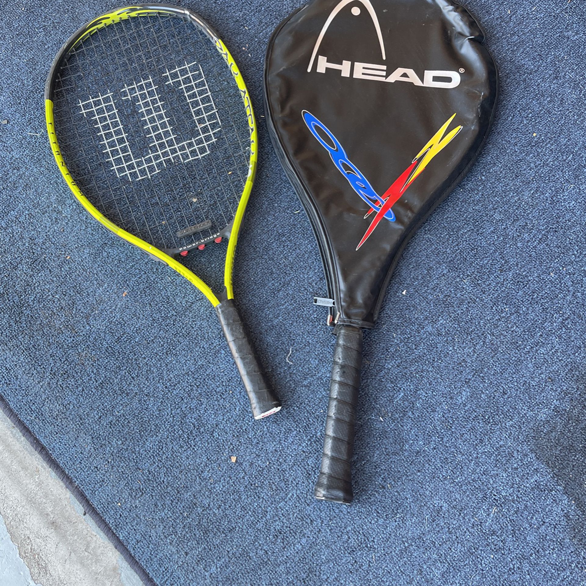 One Wilson Tennis Racket And One Head Tennis Racket