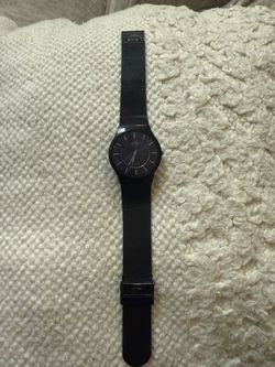 This Skagen Men's Titanium watch features a slim black case and a matching black stainless steel mesh band with a striking dark blue dial.