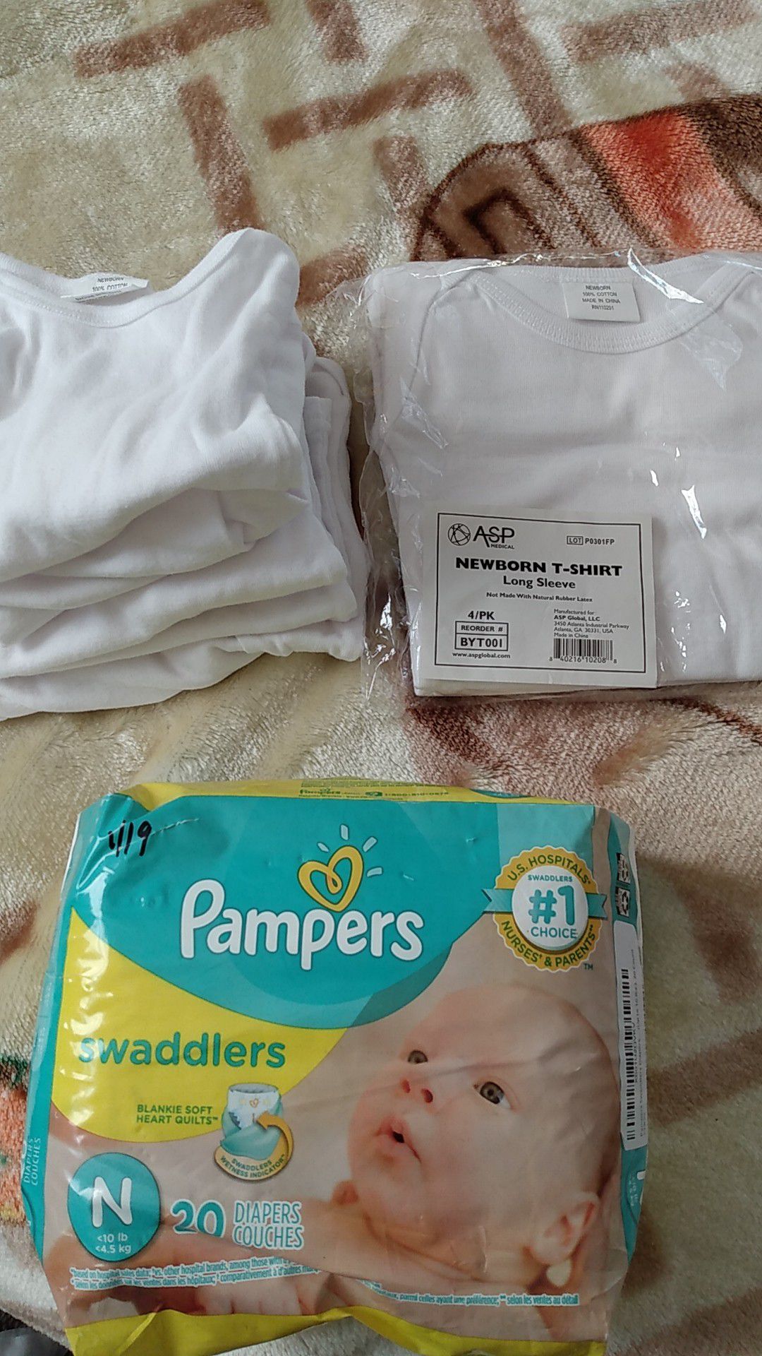 Newborn 4 pack long sleeve t-shirt and Newborn swaddlers Pampers