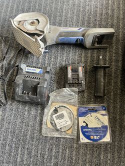 Dremel And 2 Blades And Battery And Charger.