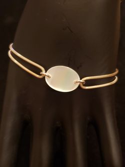 STERLING mother of pearl double strand bracelet. Marked 925. Bracelet is 7.5 in long. Mother of pearl is 1/2 in long.