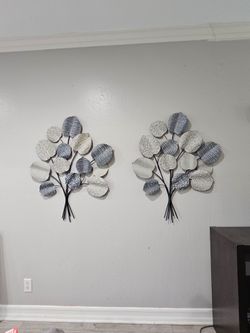 Beautiful set of two dimensional metal wall sculptures featuring textured leaves in soft blue, cream