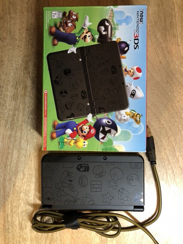 Nintendo 3DS Super Mario Black Edition with one game and charging wire