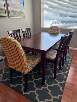 Dark wood dining table with 6 chairs