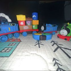 Thomas the Tank Engine (remote control & Pull along) & Percy Press 'n Go Stunt toys.