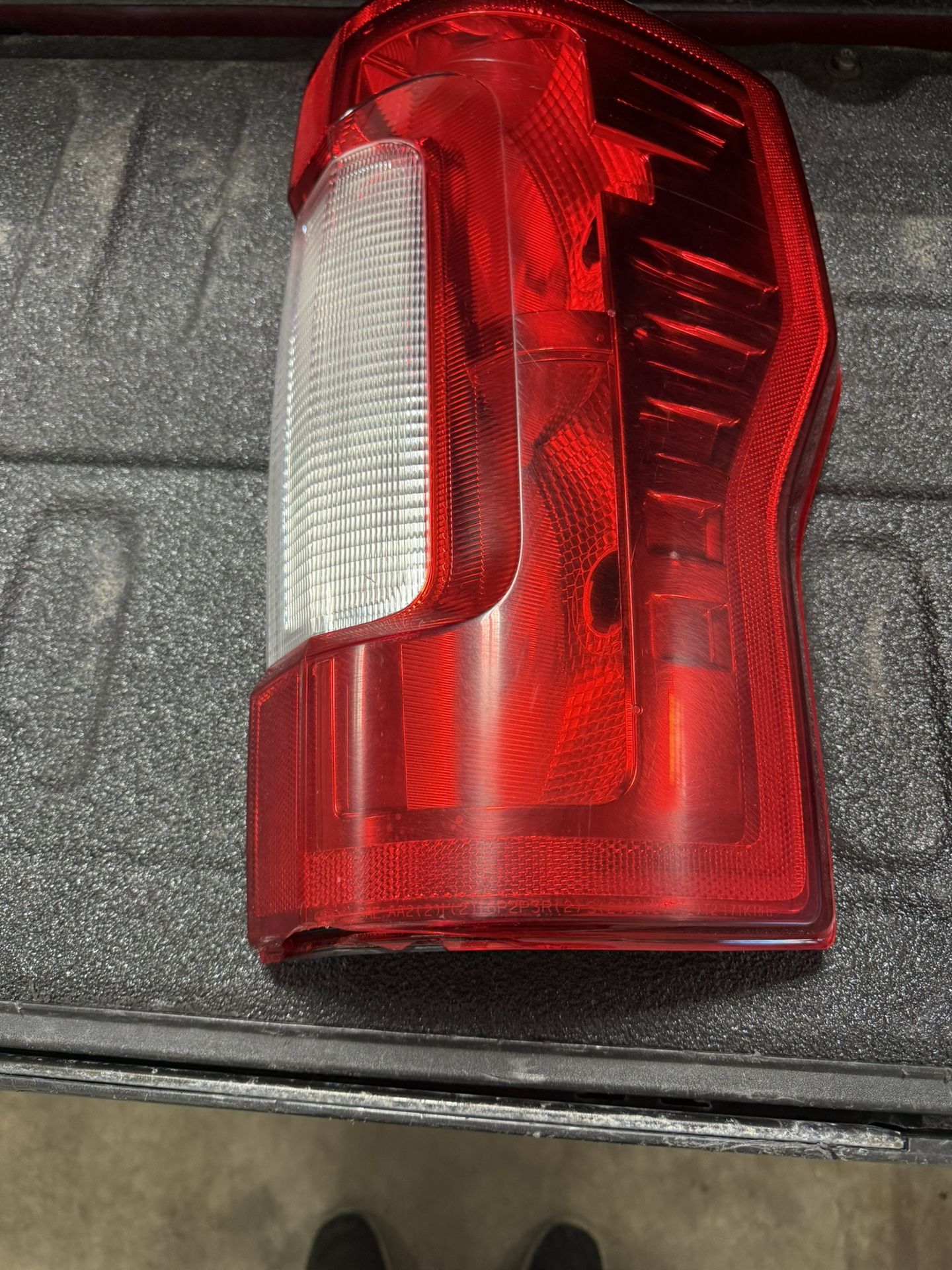 oem Ford f350 passenger side tail light. Has a small crack at the bottom. Barely visible.