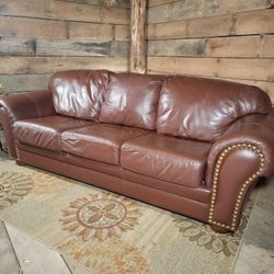 Genuine leather Leather Center brand burgundy sofa with removable bottom and back cushions