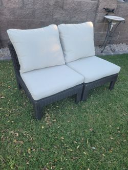 Pair of outdoor wicker armless chairs with cushions