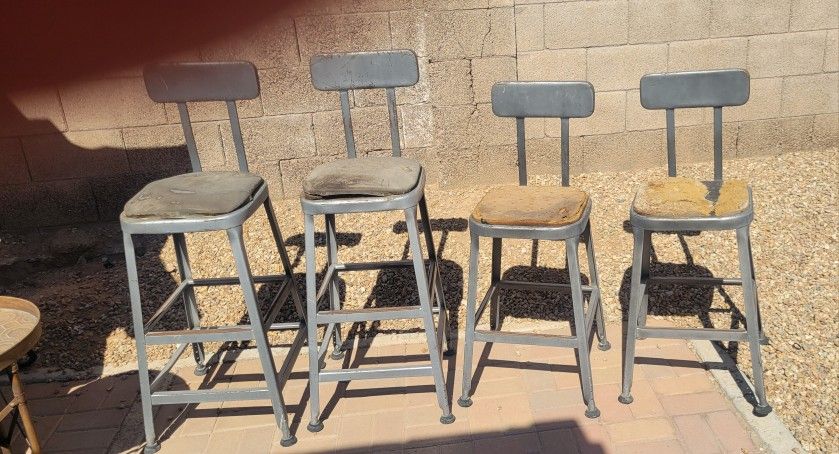 Four steel Vintage high top stools