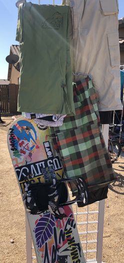 Snowboard and three snow pants