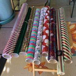 Nine Rolls Of X-más Wrapping Paper All For $