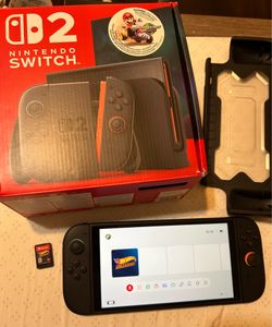 Nintendo Switch 2 console with box, dock, cords, and Hot wheels unleashed