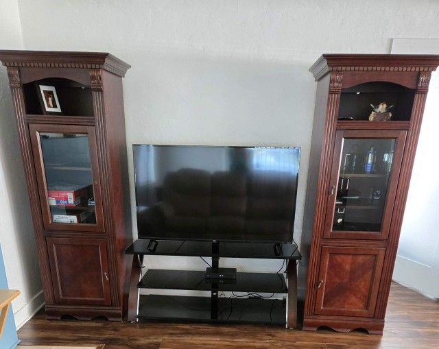 Two-piece Entertainment Center / Armoire Cabinet. Dark wood.