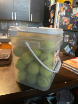 Container of old tennis balls
