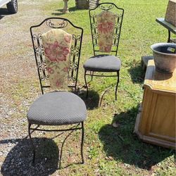 Two iron chairs sturdy could use some new fabric