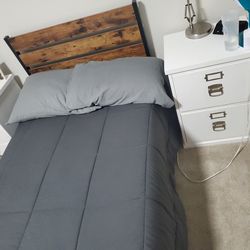 Twin bed frame with memory foam mattress.