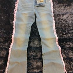 IamGia blue jeans with pink ribbon ties laced down side cutouts on both legs . Super cute . . Size 5