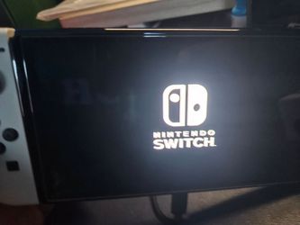 Nintendo switch Oled w/64 sd card and controller grip