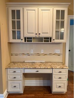 Cream built in wood desk with granite top and matching hutch