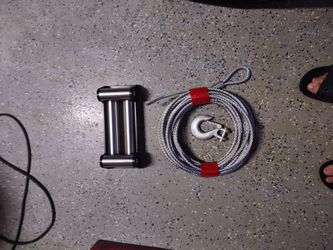 Winch roller fairlead and steel cable.