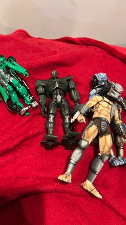 4 figures including predator, pacific rim, and transformers