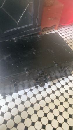 Large black antique metal footlocker