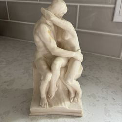 Grecian Man And Woman Sharing A Kiss