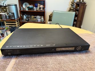Black Oppo DV-980H DVD player with 1080p upscaling and HDMI output. This unit has a front-loading disc tray, a digital display, and a USB 2.0 port. It