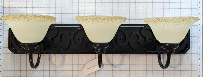 3 Light Fixture w Black Metal w Frosted White Glass Globes w Gold Splash Around Top Edge. NEW