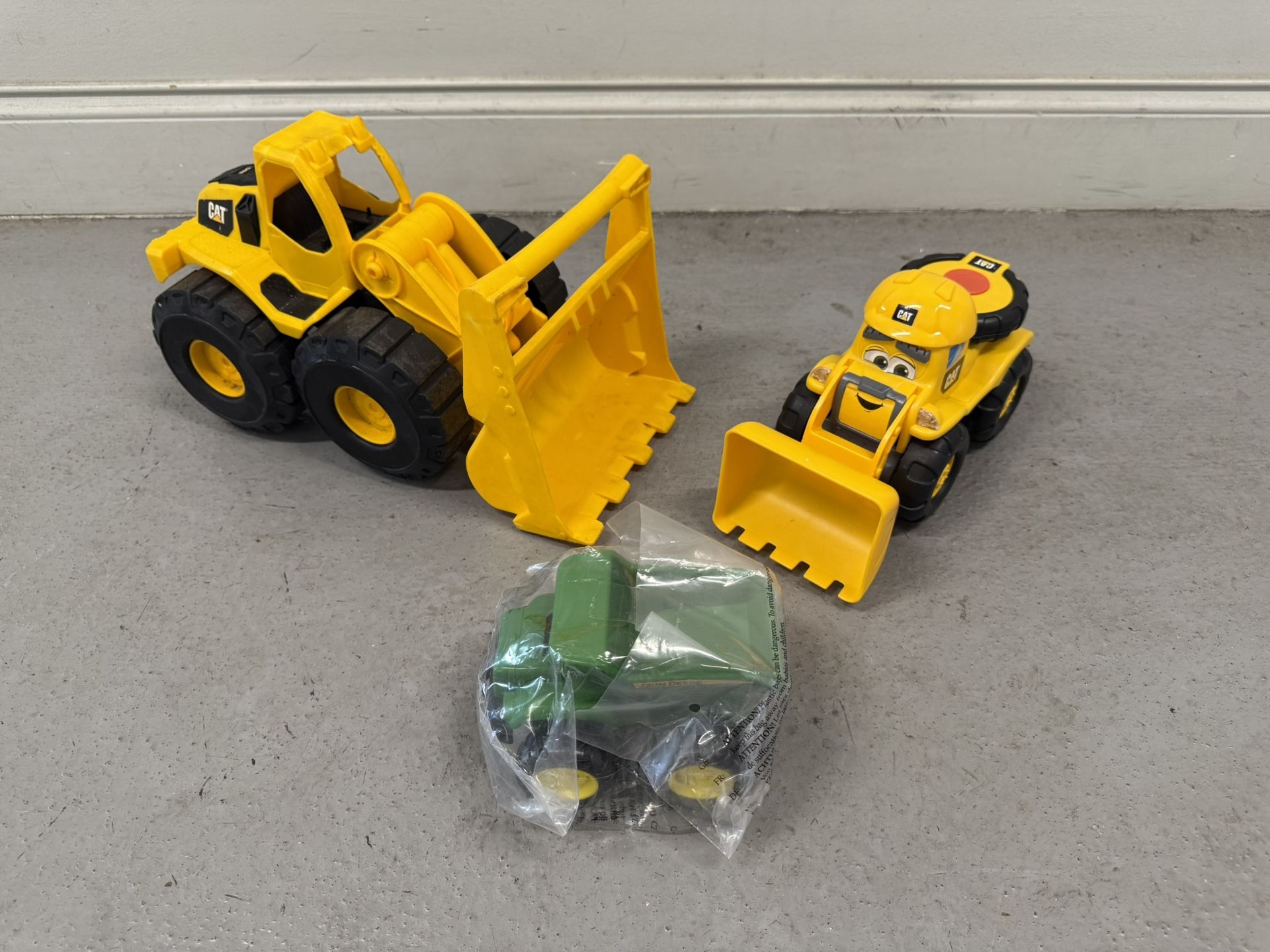CAT, JOHN DEERE Toy Trucks. Three Toy Trucks (Good condition) PICK UP IN CORNELIUS CAT Lil' Movers Wheel Loader CAT Construction Fleet Toy Bulldozer